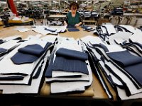 Maria Pereira, selects the material for matching pattern and stitching for the coat pockets, at the Joseph Abboud manufacturing plant in New Bedford, MA.   [ PETER PEREIRA/THE STANDARD-TIMES/SCMG ]